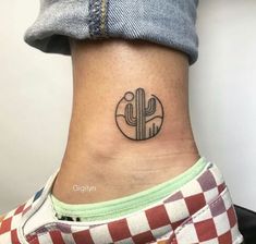 a woman's ankle with a small cactus tattoo on her left side ribcage