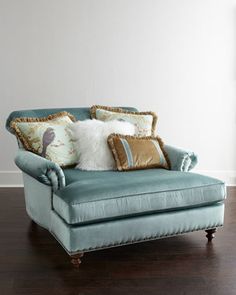 a blue chair with some pillows on it