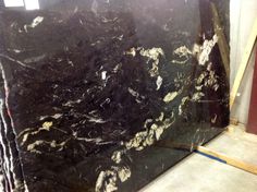 a black marble slab is being worked on