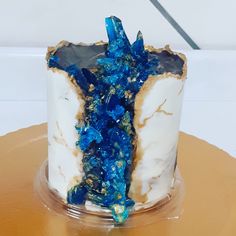 a cake with blue and gold decorations on it