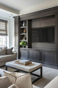 a living room filled with furniture and a flat screen tv mounted on a wall above a coffee table