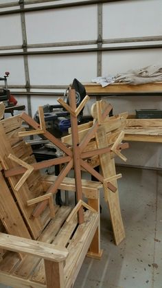 a snowflake made out of wood sitting on top of a wooden bench in a garage