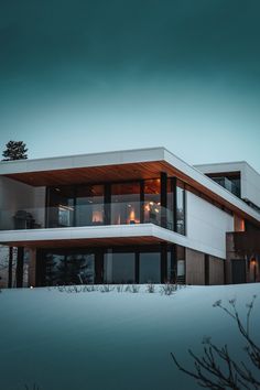 a modern house in the snow at night