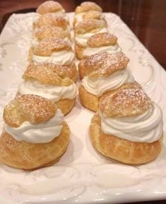 small pastries are arranged on a white platter