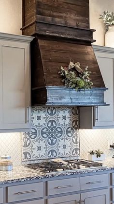 a stove top oven sitting inside of a kitchen next to wooden cabinets and counter tops