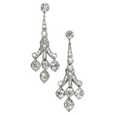 A pair of Art Deco diamond drop earrings, with a geometric and scrolling, articulating design, with baguette and old-cut diamonds, in rub over and grain settings, with three, old-cut diamonds suspended below, in marquise shape settings, mounted in platinum, circa 1920. The estimated total diamond weight is 4.00 carats. Luxury Art Deco Diamond Earrings As Gift, Luxury Art Deco Diamond Earrings With Brilliant Cut, Art Deco Diamond Earrings Hallmarked, Silver Art Deco Platinum Diamond Earrings, Art Deco Platinum Diamond-studded Jewelry, Diamond Drop Earrings, Diamond Drops, Art Deco Diamond, Dream Jewelry