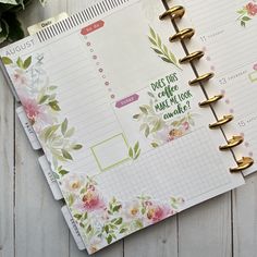 an open planner book sitting on top of a wooden table