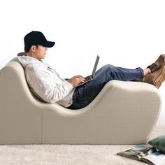 a man sitting on a couch using a laptop computer