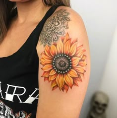 a woman with a sunflower tattoo on her arm