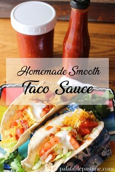 homemade smooth taco sauce in a bottle and two tacos on a plate