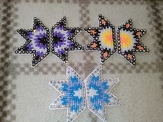 three pieces of beaded fabric with different shapes and colors on them, one is blue, the other is purple