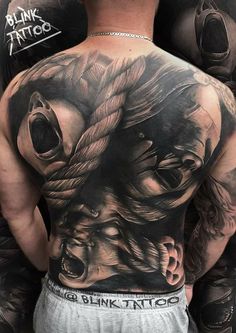 the back of a man's torso with an image of a demon on it