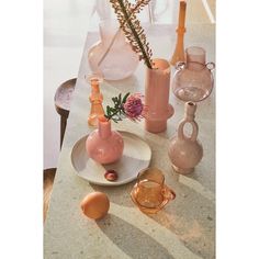 there are many vases on the table with one flower in it and two empty ones