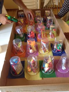 a box filled with lots of different types of cups and containers on top of a table