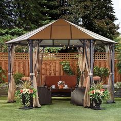 a gazebo sitting on top of a lush green field