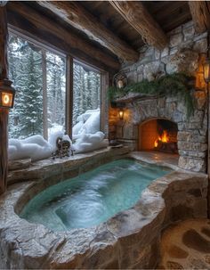 an indoor hot tub in front of a stone fireplace