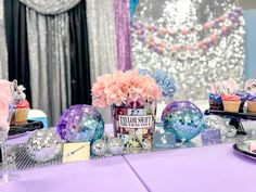 a purple table topped with lots of cupcakes