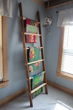 a ladder leaning up against a wall in a room with blue walls and white tile flooring