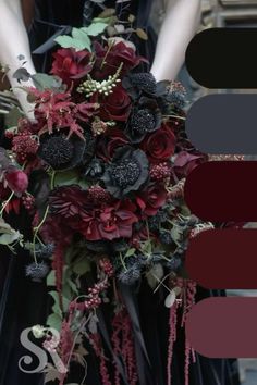 a woman in a black dress holding a red and purple wedding bouquet with greenery