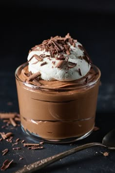 a chocolate dessert with whipped cream and chocolate shavings