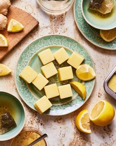 sliced lemons and cubed cheese on plates