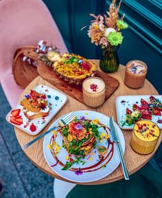 a wooden table topped with plates of food