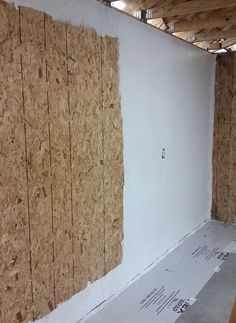 an unfinished room with plywood walls and drywall