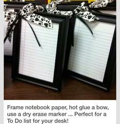 two frames with writing paper tied to them on top of a table next to each other