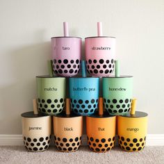 a stack of colorful cups sitting on top of each other in front of a wall