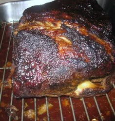 a large piece of meat sitting on top of a metal rack in an oven with the words perfect pork roast over it