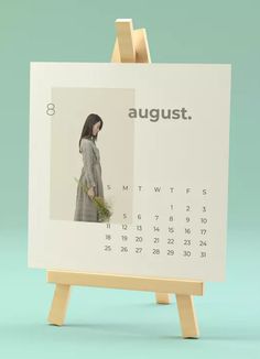 a calendar with an image of a woman holding a plant in her hand and the words august on it