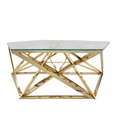 a glass and gold coffee table with geometric shapes on the top, against a white background