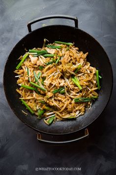 stir fry with chicken and green beans in a wok on a black table top