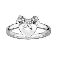 This sterling silver ring is sweet and chic. Sparkling diamond accents adorn the bow and heart design. Express your charming sense of style when you wear this ring with another stack ring. Rhodium plating lends extra radiance to the sterling silver construction. Details:  3/8-in. width Rhodium-plated sterling silver Image(s) may be enlarged to show detail. Diamond weights are approximate. Diamond total weights may vary between .01 and .08 ct. Some diamonds have fewer than 17 facets.  Gemstones m Coquette Jewelry, Future Christmas, Jewellery Board, Airpod Cases, Diamond Bows, Sterling Silver Stacking Rings, Bracelet Pendant, Sparkly Jewelry, Stack Ring