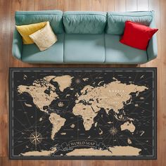 a living room with a blue couch and a world map on the wall above it