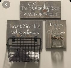 two wooden signs hanging on the wall next to a wire basket with a stuffed animal in it