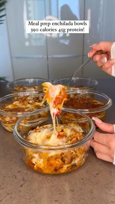 a person is dipping some food into a glass bowl with a spoon in it and the words meal prep enchilada bowls 39 calories 488 protein