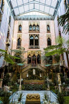 the inside of a building with many windows and plants