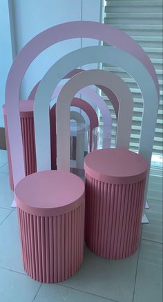 pink and white furniture is displayed on the floor