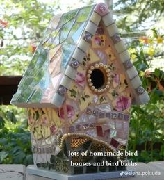 a bird house made out of glass and flowers