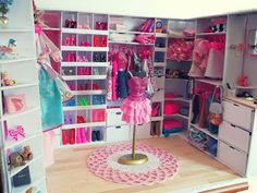 a doll's closet with clothes, shoes and other items in the room on shelves