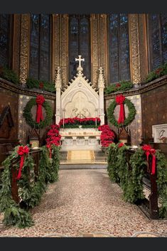 a church decorated for christmas with wreaths and decorations