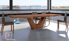 a large wooden table sitting in front of a window next to two chairs and a bench