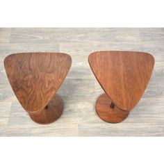 two wooden stools sitting on top of a hard wood floor next to each other