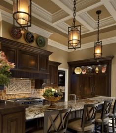 a large kitchen with wooden cabinets and marble counter tops