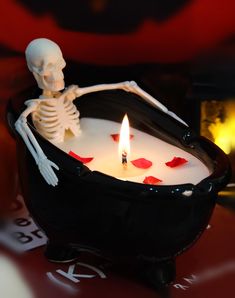 a candle with a skeleton sitting in it