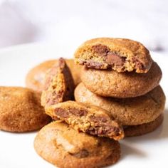 a pile of cookies sitting on top of a white plate