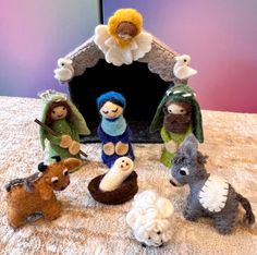 a group of stuffed animals sitting on top of a bed next to a small dog house