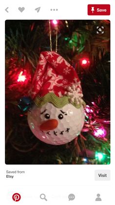 a snowman ornament hanging from a christmas tree