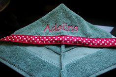 a blue towel with red and white polka dots on it that says, addine